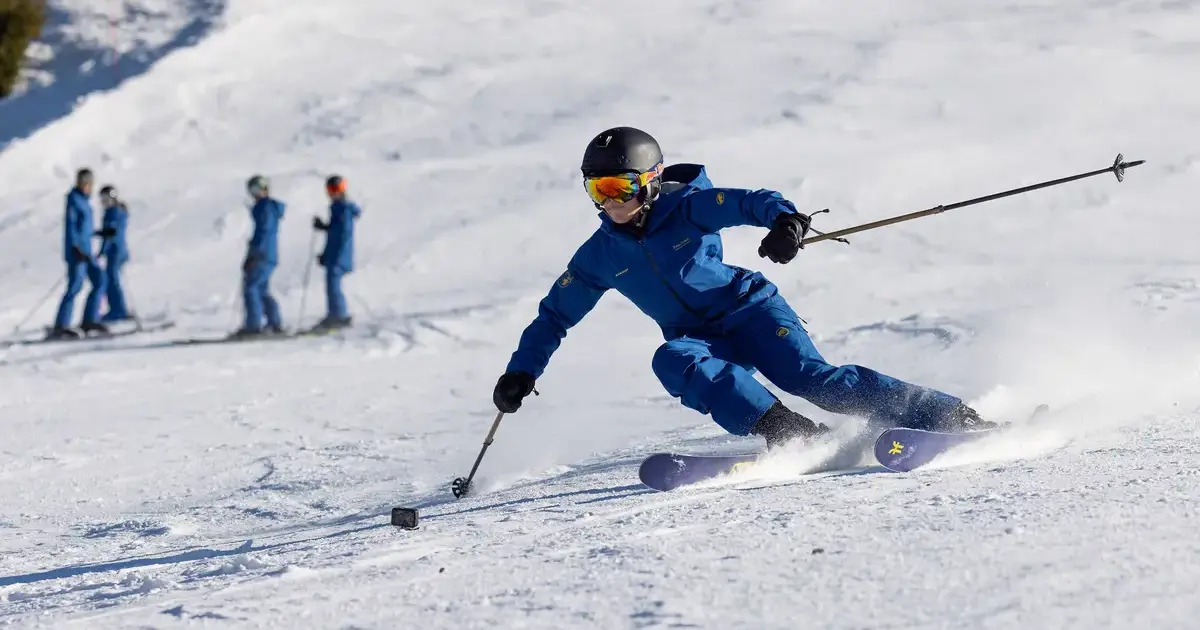 Student skiing down a slope